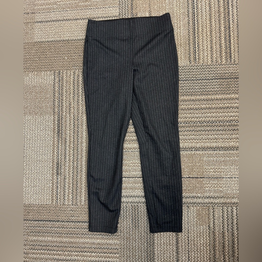 Polyester Rayon Spandex blend. Large band on the top.